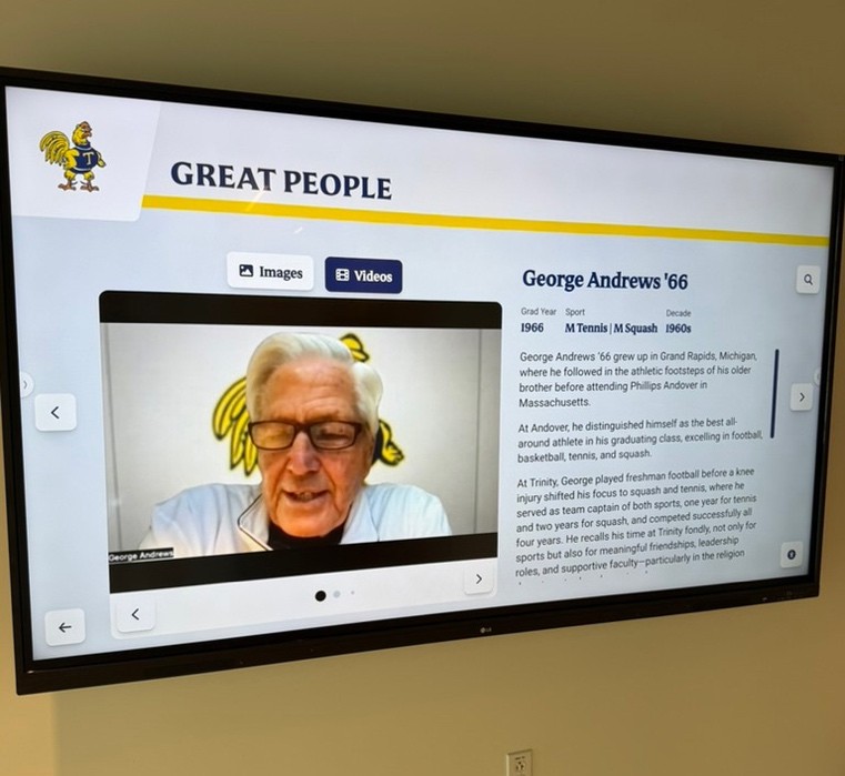 The interactive platform installed on a wall-mounted screen inside the Scully Wellness & Recreation Center, showing a profile of George Andrews '66.